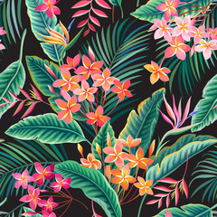 seamless floral pattern with tropical leaves and flowers on black