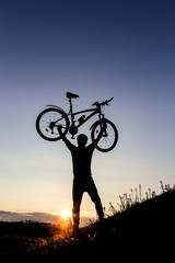 Cyclist man silhouette and mountain bike.