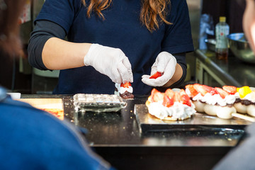 Japanese girl cook Is preparing desserts for customers in Kyoto, Japan