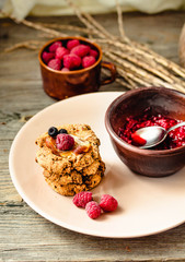 Homemade oatmeal cookies with banana, oats, nuts, eggs and flour free on grey wooden table, side view.