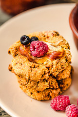 Oatmeal vegan cookies with raspberry jam and date caramel. Close-up.