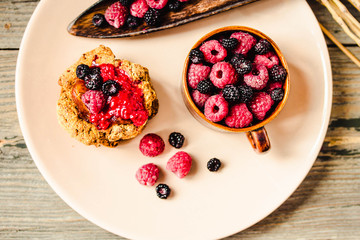 Homemade wholegrain cookies with oatmeal, lin and sesame seeds on rustic wooden table. Healthy vegan wholegrain cookies. Top view.