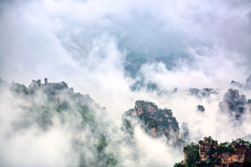 Zhangjiajie National park. Famous tourist attraction in Wulingyuan, Hunan, China. Amazing natural landscape with stone pillars quartz mountains in fog and clouds