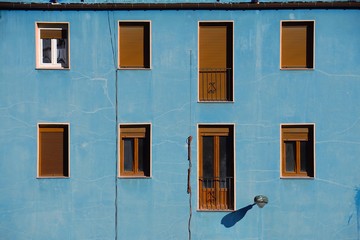 Obraz na płótnie Canvas window on the blue building facade in Bilbao city Spain, window in the street