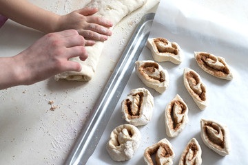 Children mold cheesecakes from dough. Kitchen table in flour. Warm relationships children