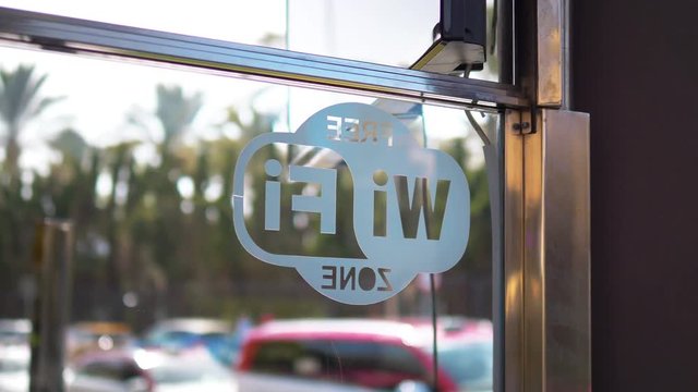 Free wi fi zone sign on the window in 4k slow motion 60fps