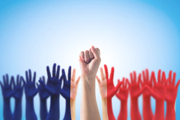 France national flag pattern on leader's fist among people's palm hands  raising up on blue background