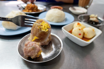 Shrimp dumpling on fork in restaurant