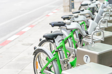 Obraz premium green bicycle for rent in city / bike for rent