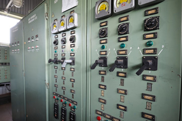 At the control operations room. Clouse up of a main control board: tumblers, manometers, buttons