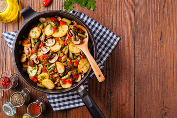 Fried pan vegetables, with mushrooms and dried tomatoes. Seasoned with a mix of herbs.