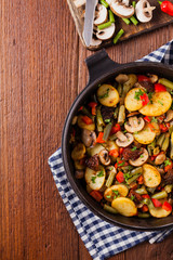 Fried pan vegetables, with mushrooms and dried tomatoes. Seasoned with a mix of herbs.