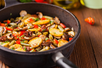Fried pan vegetables, with mushrooms and dried tomatoes. Seasoned with a mix of herbs.