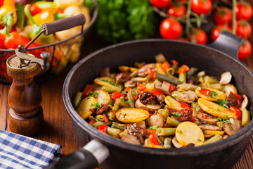 Fried pan vegetables, with mushrooms and dried tomatoes. Seasoned with a mix of herbs.