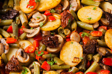 Fried pan vegetables, with mushrooms and dried tomatoes. Seasoned with a mix of herbs.