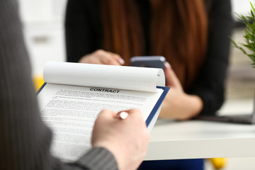 Male arm fill form clipped to pad with silver pen