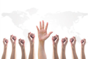 Empowering women power, human rights and labor day concept with strong fist and hands raising up on world map