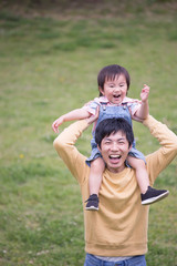 Fototapeta premium 肩車する若い父親、育児イメージ