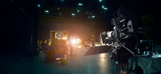 Behind the scenes of making of movie and TV commercial. Camera of movie and video production. Film Crew. B-roll, and crew team in studio and set on dark background - obrazy, fototapety, plakaty