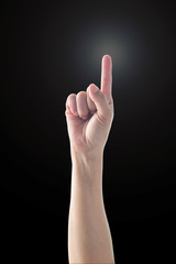 Pointing finger woman's hand with rim light isolated on black background (clipping path) for number one 1, showing direction, go straight forward, good ides