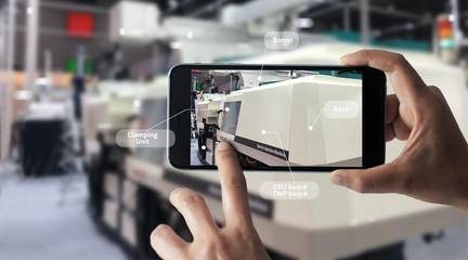 Augmented reality concept. AR. Industrial 4.0 , Hand of engineer holding mobile smart phone using...