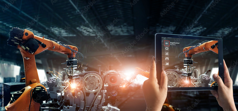 Aufkleber Augmented reality industry. Hand holding digital tablet use AR application to check and control welding robotics automatic arms machine in factory automotive industrial with monitoring system software