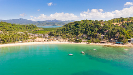 Fototapeta na wymiar Las Cabanas Beach. Islands and beaches of El Nido.Tropical islands with white sandy beaches, aerial view.Tourists relax on the white beach.
