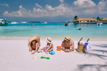 Family with three year old boy on beach