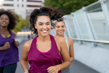 Cheerful latin woman jogging