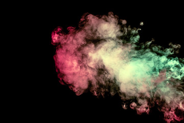 Beautiful column of smoke in the neon bright light of red, green, pink and turquoise on a black background exhaled out of the vape. Nice pattern for printing and backdrop of colored waves.