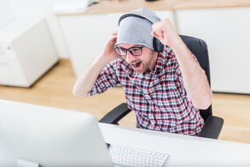 Happy gamer at his desktop computer.