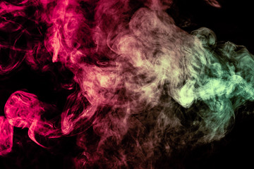 Beautiful column of smoke in the neon bright light of red, green, pink and turquoise on a black background exhaled out of the vape. Nice pattern for printing and backdrop of colored waves.