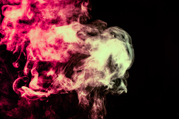 Beautiful column of smoke in the neon bright light of red, green, pink and turquoise on a black background exhaled out of the vape. Nice pattern for printing and backdrop of colored waves.