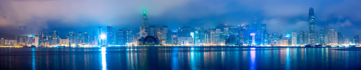 Hong Kong skyline panorama in the morning over Victoria Harbour during twilight sunrise.