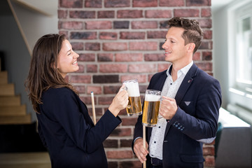 Young fashionable snooker players holding beer mugs.