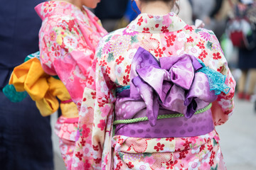 Young girl wearing Japanese kimono standing in front of Sensoji Temple in Tokyo, Japan. Kimono is a Japanese traditional garment. The word "kimono", which actually means a "thing to wear"