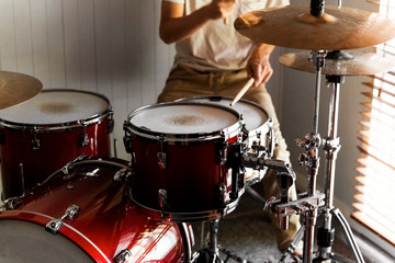 Fototapeta na wymiar Drummer practicing rudiments on his home drum kit.