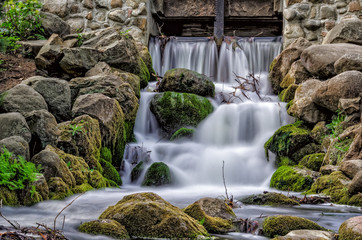 FOOTBRIDGE OVER THE STREAM - A small waterfall in a city park
