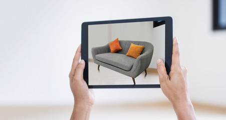 AR augmented reality. Hand holding digital tablet, AR application, simulate sofa furniture and and interior design  real room background, modern technology. - obrazy, fototapety, plakaty