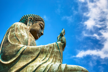The big Tian Tan Buddha at Po Lin Monastery in Hong Kong during summer sunny day.