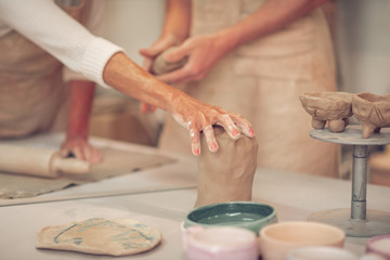 Fototapeta na wymiar Close up of female hand touching clay piece