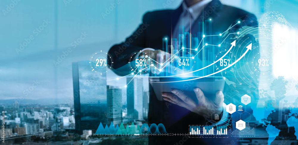Leinwandbilder Digital marketing. Business strategy. Businessman using tablet analyzing sales data and economic growth graph chart on hologram screen. Business strategy and digital data.