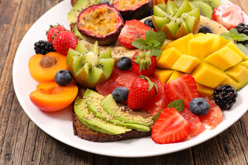 mixed fruit and toast with avocado