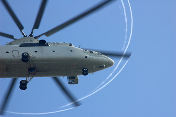 large helicopter with beautiful stripes of propellers in the air, view from the bottom
