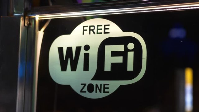 Free wi fi zone sign on the window in 4k slow motion 60fps