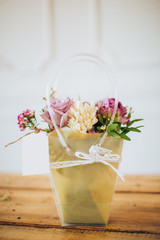 pink box with flowers. box with peony roses and white tulips. garden flowers in flower pots. wildflowers. gift for mothers day. flowers for valentines day. flowers on a wooden table.