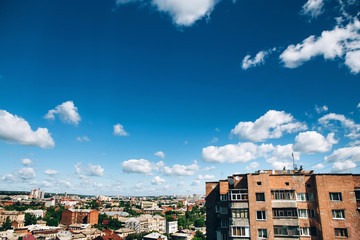 Naklejka premium high-rise residential building in eastern europe. blue sky over the city. residential building. shabby high-rise building.