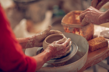Close up of female hands molding the pot