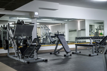 Fototapeta na wymiar Modern interior of light gym with different equipment