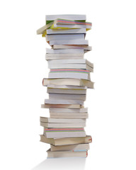 Education and reading concept. Stack of books isolated on white background, backlight.